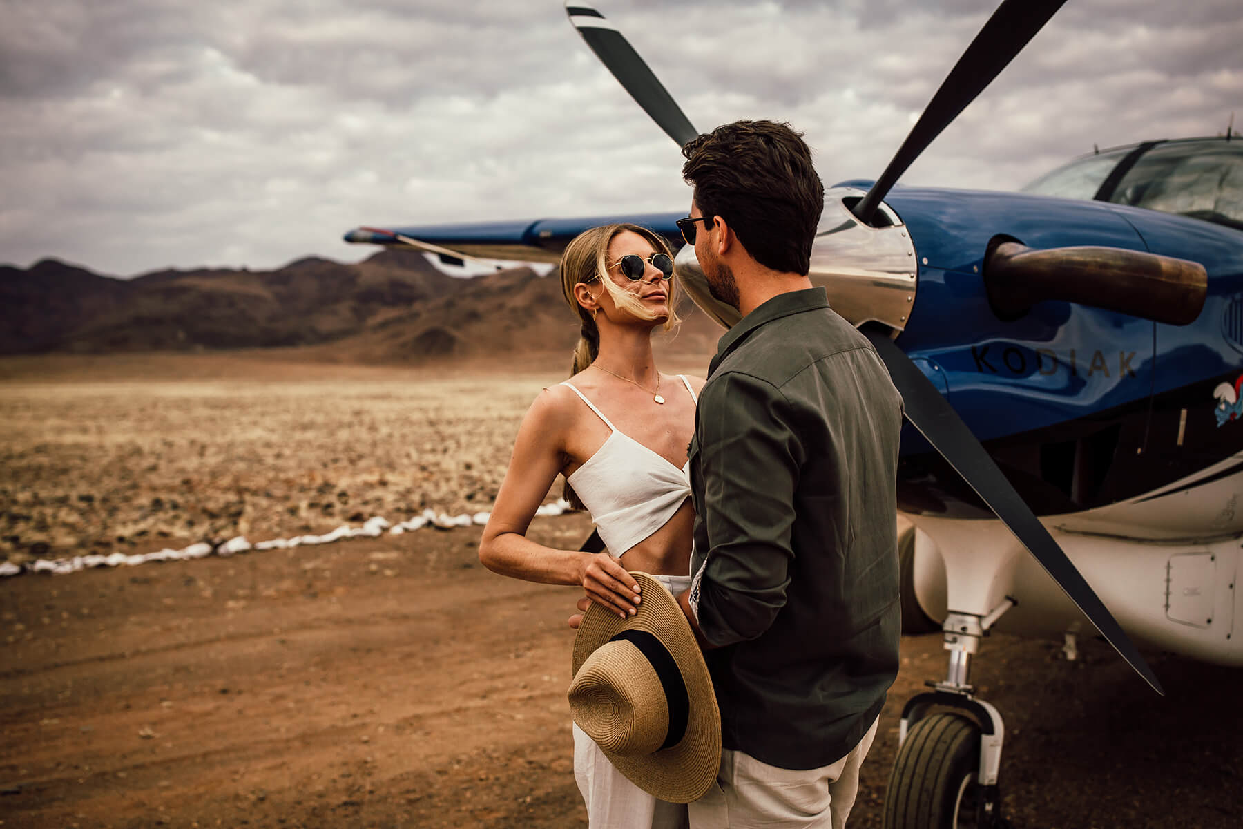 couple with small airplane in namibia africa